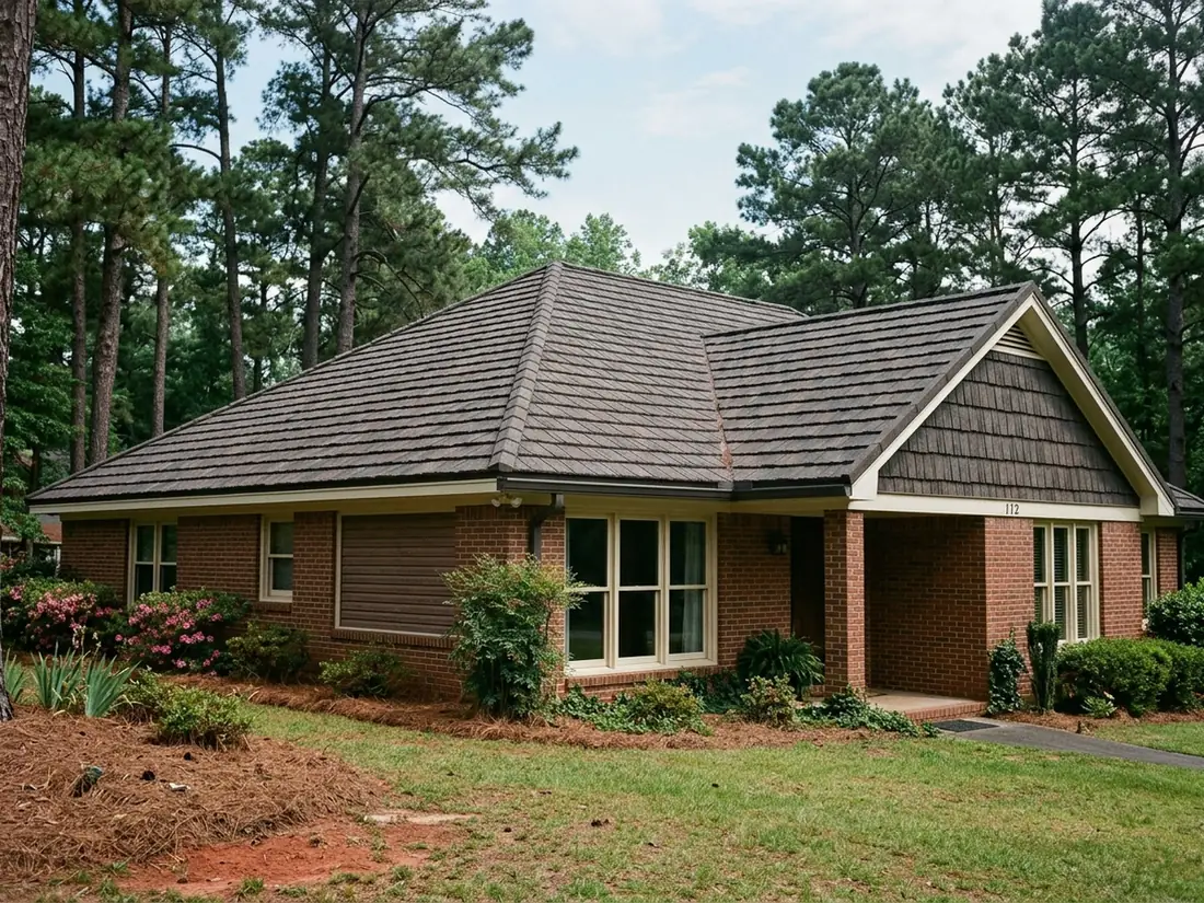 Stone-coated steel shake panels with textured brown granules on a brick ranch roof